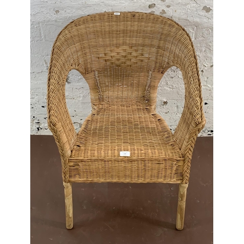 114 - A wicker armchair - approx. 77cm high x 58cm wide x 60cm deep