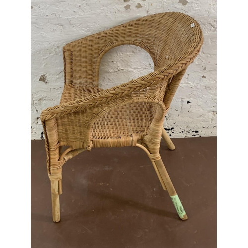 114 - A wicker armchair - approx. 77cm high x 58cm wide x 60cm deep