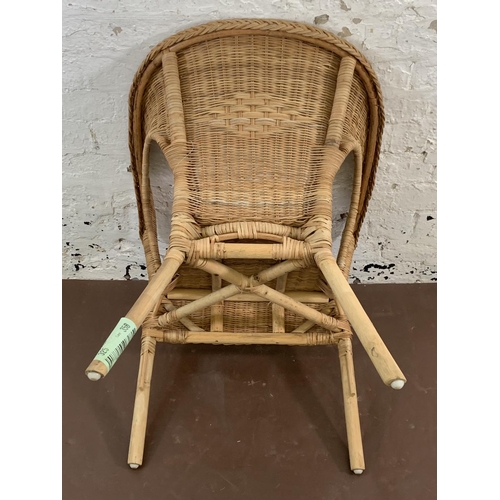 114 - A wicker armchair - approx. 77cm high x 58cm wide x 60cm deep