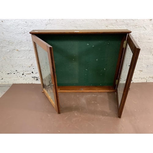 117 - A mid 20th century oak wall mountable display case with two glazed doors - approx. 66cm high x 86cm ... 