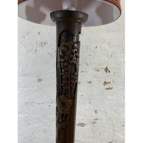 118 - A Chinese carved camphor wood standard lamp with circular base and shade - approx. 180cm high