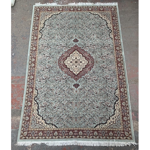 12 - A 20th century machine woven rug - approx. 290cm x 188cm