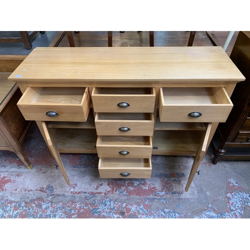 120 - A modern oak sideboard - approx. 85cm high x 140cm wide x 45cm deep