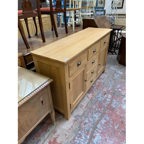 120 - A modern oak sideboard - approx. 85cm high x 140cm wide x 45cm deep