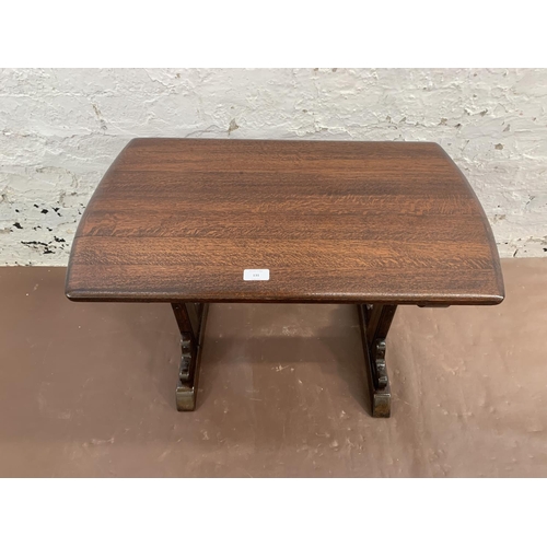 131 - An oak rectangular trestle coffee table - approx. 48cm high x 42cm wide x 68cm long