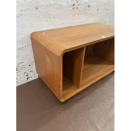 132 - A mid 20th century teak media unit on castors - approx. 58cm high x 100cm wide x 50cm deep