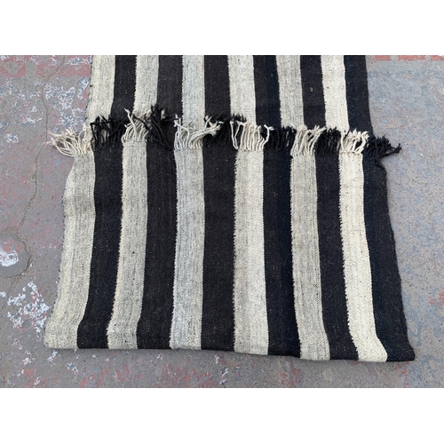 14 - A mid 20th century black and white Kilim hall runner/rug - approx. 245cm x 95cm