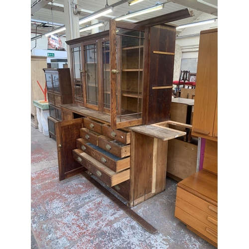 149 - A late 19th/early 20th century oak shop display cabinet with four glazed doors, two lower cupboard d... 