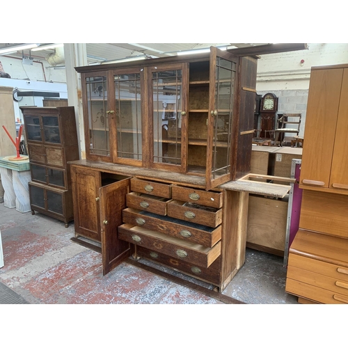 149 - A late 19th/early 20th century oak shop display cabinet with four glazed doors, two lower cupboard d... 