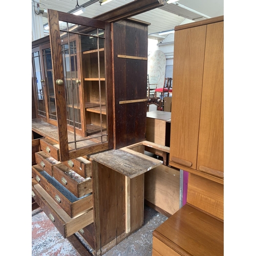 149 - A late 19th/early 20th century oak shop display cabinet with four glazed doors, two lower cupboard d... 