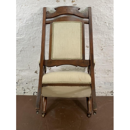 160 - An Art Nouveau carved mahogany and fabric upholstered armchair - approx. 110cm high x 65cm wide x 63... 