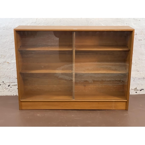 161A - A mid 20th century Turnidge of London teak bookcase with two glass sliding doors - approx. 90cm high... 