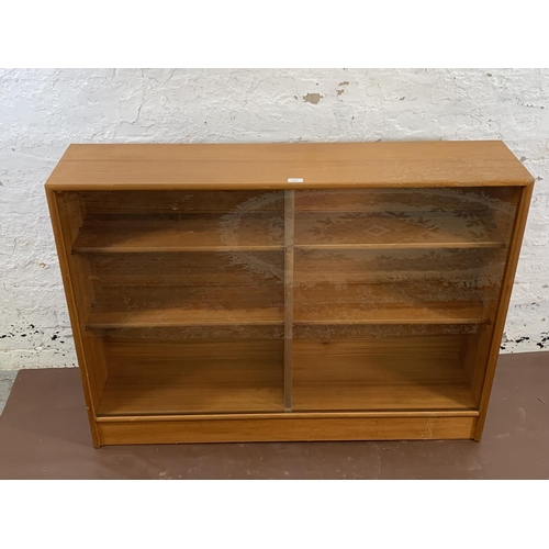 161A - A mid 20th century Turnidge of London teak bookcase with two glass sliding doors - approx. 90cm high... 