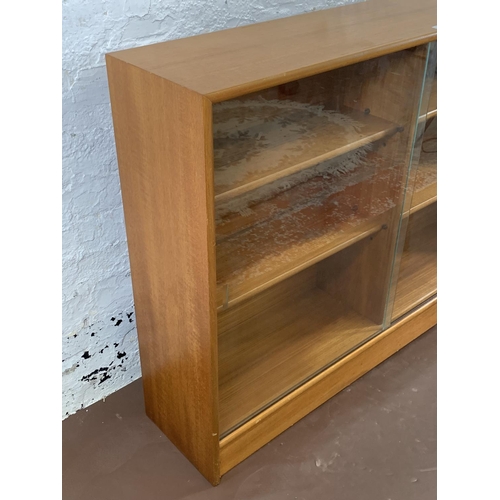 161A - A mid 20th century Turnidge of London teak bookcase with two glass sliding doors - approx. 90cm high... 