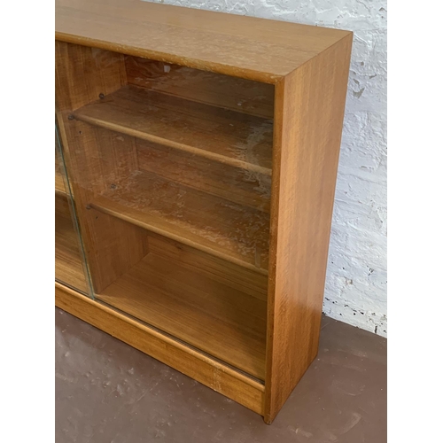 161A - A mid 20th century Turnidge of London teak bookcase with two glass sliding doors - approx. 90cm high... 