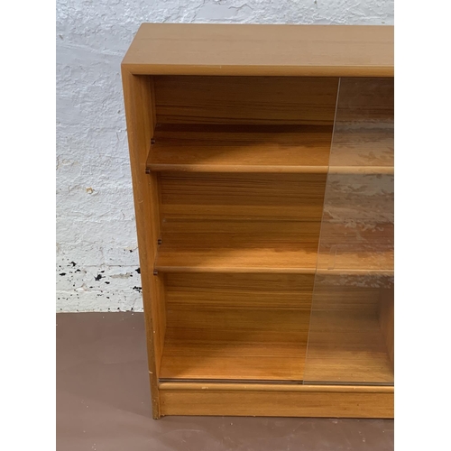 161A - A mid 20th century Turnidge of London teak bookcase with two glass sliding doors - approx. 90cm high... 