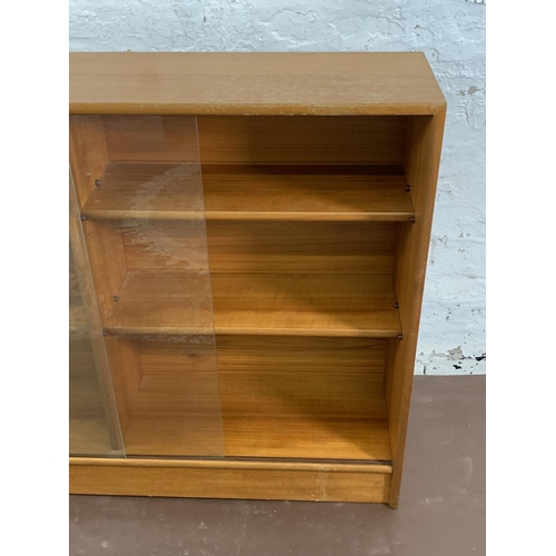 161A - A mid 20th century Turnidge of London teak bookcase with two glass sliding doors - approx. 90cm high... 