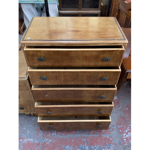 161H - An Art Deco style oak three piece bedroom suite with metal beaded decoration comprising two chests o... 