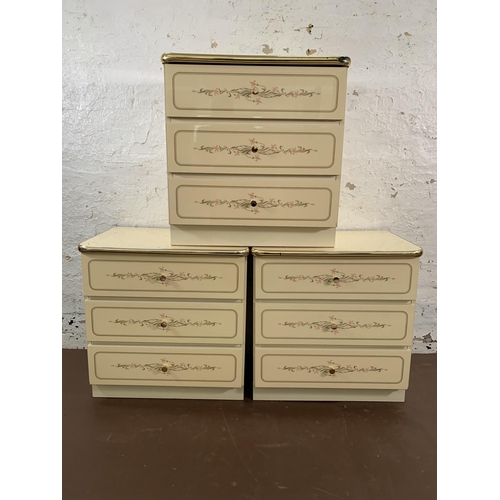 163 - Three mid/late 20th century white floral pattern melomine bedside chests of drawers - approx. 58cm h... 