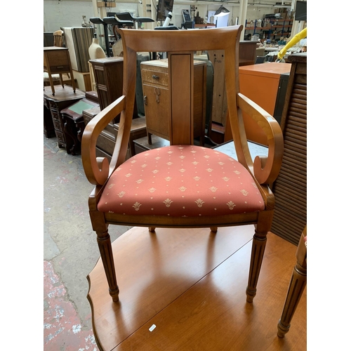 166 - A cherry wood drop leaf pedestal dining table and two carver chairs