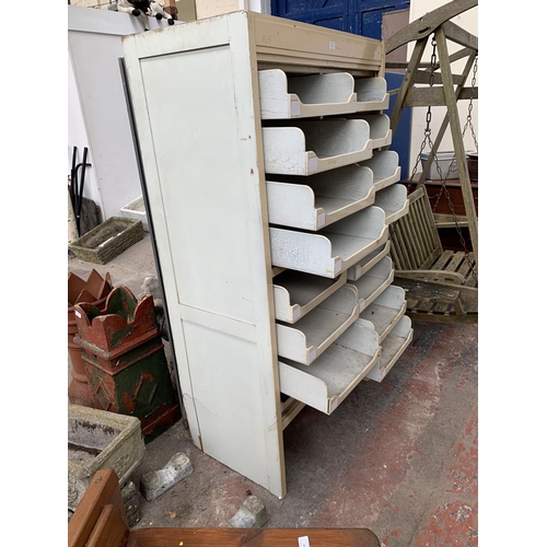 172 - A mid 20th century white painted sixteen drawer haberdashery cabinet bearing label 