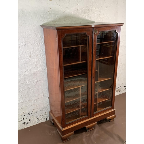 173 - A 19th century mahogany two door glazed display cabinet with Horne patent brass hinges and pigeon ho... 