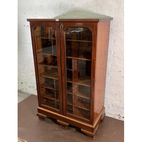 173 - A 19th century mahogany two door glazed display cabinet with Horne patent brass hinges and pigeon ho... 