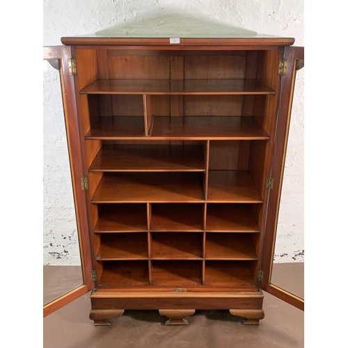 173 - A 19th century mahogany two door glazed display cabinet with Horne patent brass hinges and pigeon ho... 