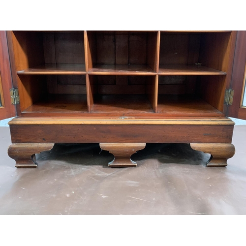 173 - A 19th century mahogany two door glazed display cabinet with Horne patent brass hinges and pigeon ho... 