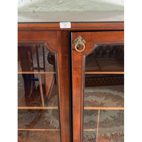 173 - A 19th century mahogany two door glazed display cabinet with Horne patent brass hinges and pigeon ho... 