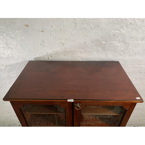 173 - A 19th century mahogany two door glazed display cabinet with Horne patent brass hinges and pigeon ho... 