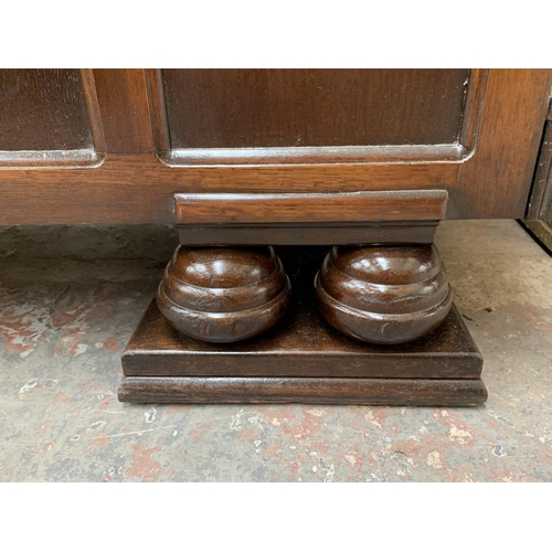 178 - An Art Deco style carved oak sideboard on baluster supports - approx. 95cm high x 122cm wide x 54cm ... 