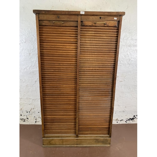 179 - An early 20th century oak two tambour door filing cabinet - approx. 152cm high x 87cm wide x 37cm de... 