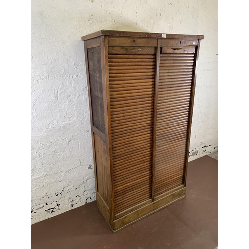 179 - An early 20th century oak two tambour door filing cabinet - approx. 152cm high x 87cm wide x 37cm de... 