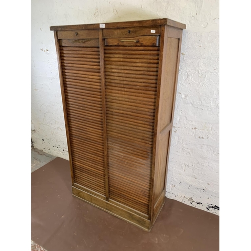 179 - An early 20th century oak two tambour door filing cabinet - approx. 152cm high x 87cm wide x 37cm de... 