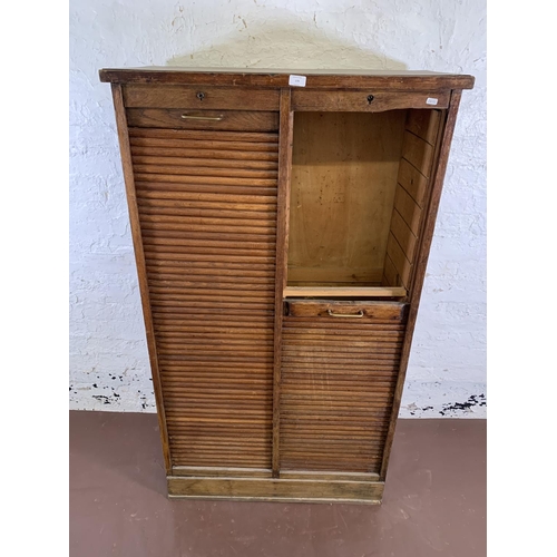 179 - An early 20th century oak two tambour door filing cabinet - approx. 152cm high x 87cm wide x 37cm de... 