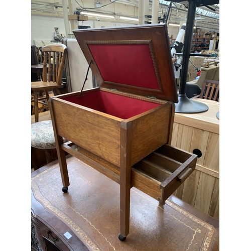 185 - A mid 20th century carved oak sewing table on castors - approx. 62cm high x 53cm wide x 35cm deep