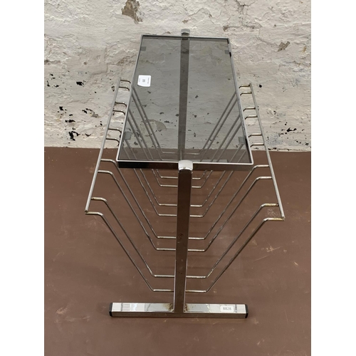 193 - A mid 20th century chrome and smoked glass magazine rack side table - approx. 39cm high x 30cm wide ... 