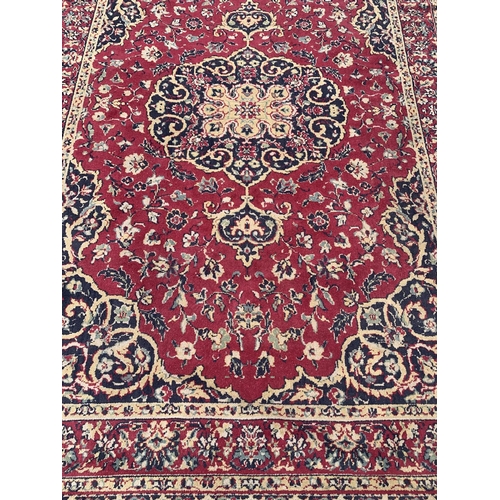 2 - A 20th century Keshan machine woven rug - approx. 283cm x 190cm