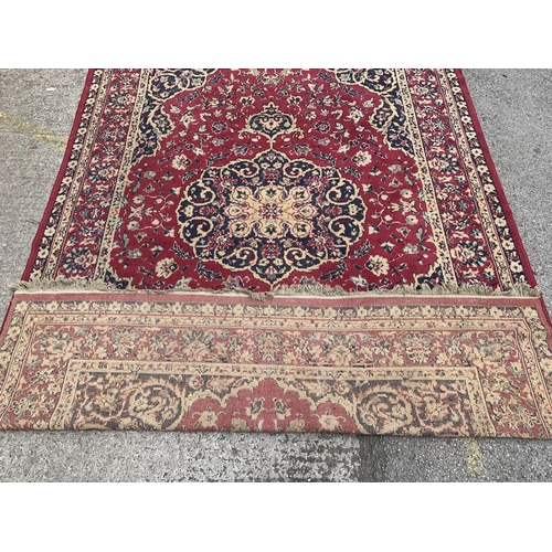 2 - A 20th century Keshan machine woven rug - approx. 283cm x 190cm