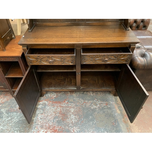 200 - A 17th century style carved oak welsh dresser - approx. 185cm high x 127cm wide x 50cm deep