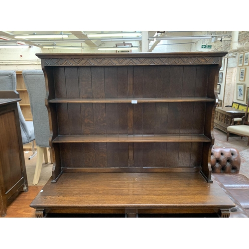 200 - A 17th century style carved oak welsh dresser - approx. 185cm high x 127cm wide x 50cm deep