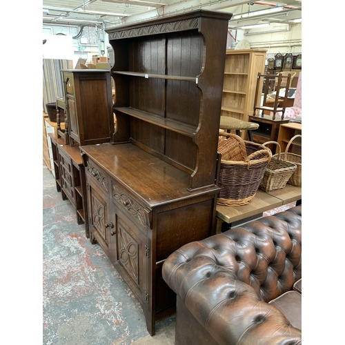 200 - A 17th century style carved oak welsh dresser - approx. 185cm high x 127cm wide x 50cm deep