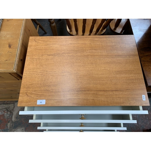 205 - A Schreiber teak effect and white laminate chest of drawers - approx. 87cm high x 60cm wide x 40cm d... 