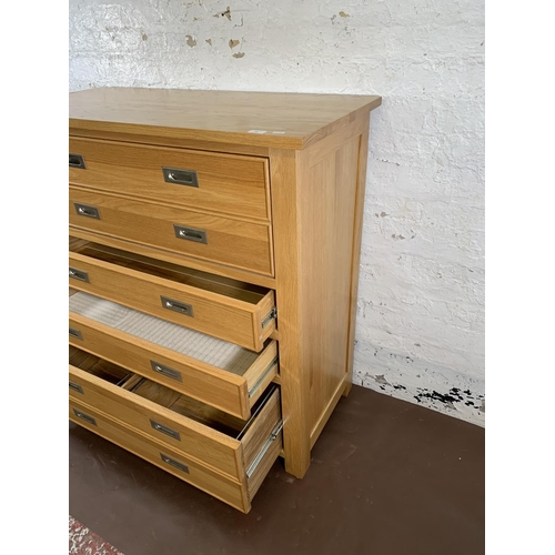 209 - A modern oak secretaire chest of drawers - approx. 114cm high x 111cm wide x 50cm deep