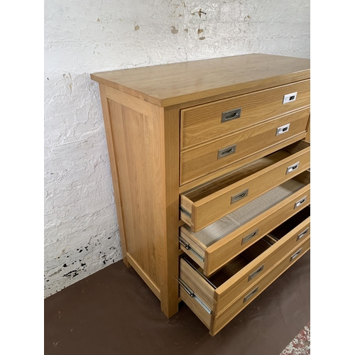 209 - A modern oak secretaire chest of drawers - approx. 114cm high x 111cm wide x 50cm deep