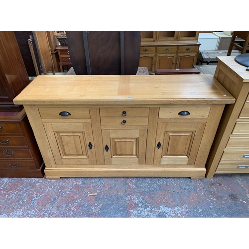 211 - A modern solid oak sideboard - approx. 97cm high x 168cm wide x 50cm deep