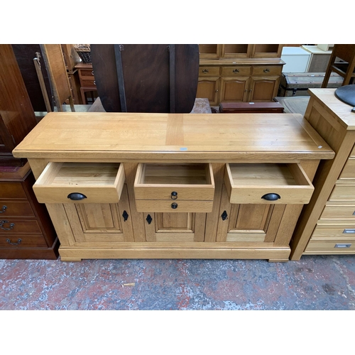 211 - A modern solid oak sideboard - approx. 97cm high x 168cm wide x 50cm deep