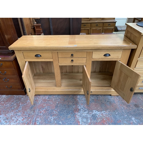 211 - A modern solid oak sideboard - approx. 97cm high x 168cm wide x 50cm deep