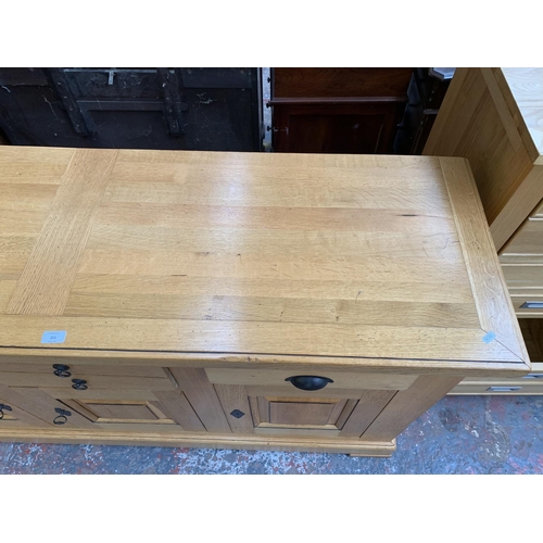 211 - A modern solid oak sideboard - approx. 97cm high x 168cm wide x 50cm deep